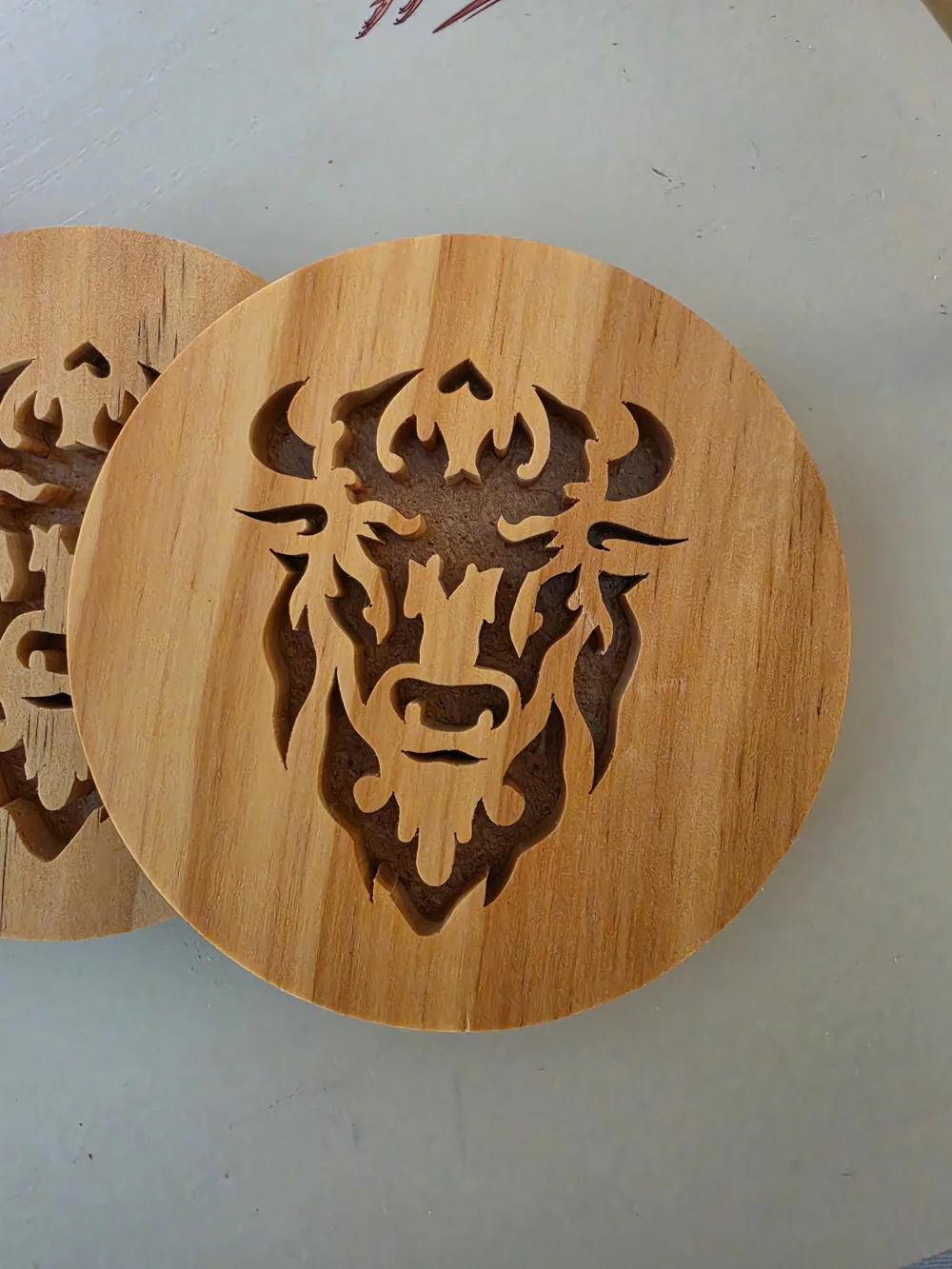 Four Wooden drink coaster set Intricate, stylized bison/buffalo head silhouette